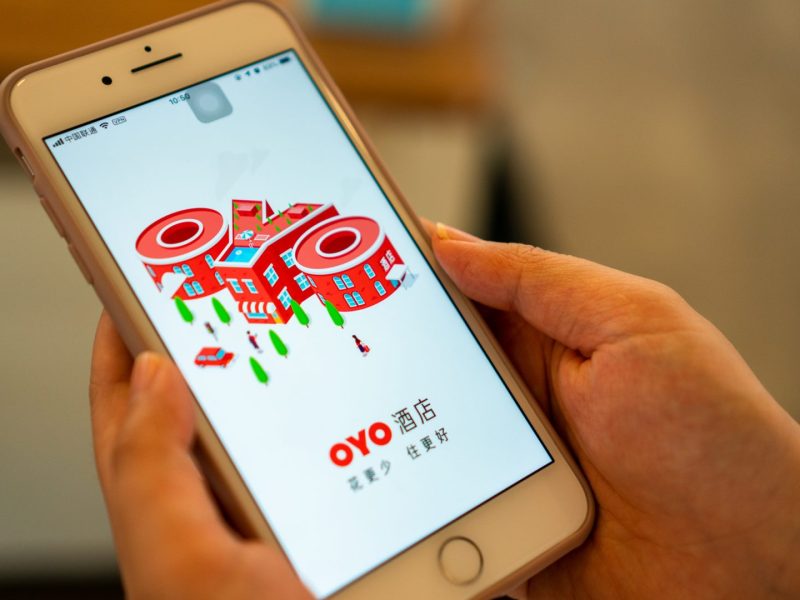 Oyo A user opens OYO's app on an iPhone. (Image credit: TechNode/Eugene Tang)